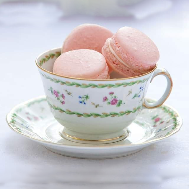 Tea cup full of pink macarons