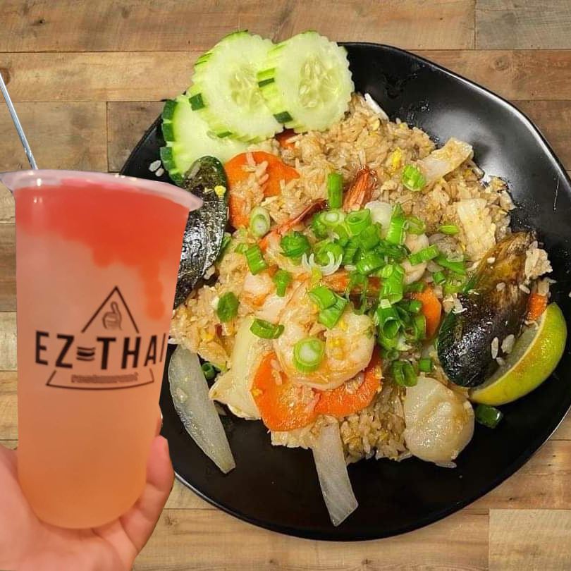 Boba tea over a plate of fried rice and chicken