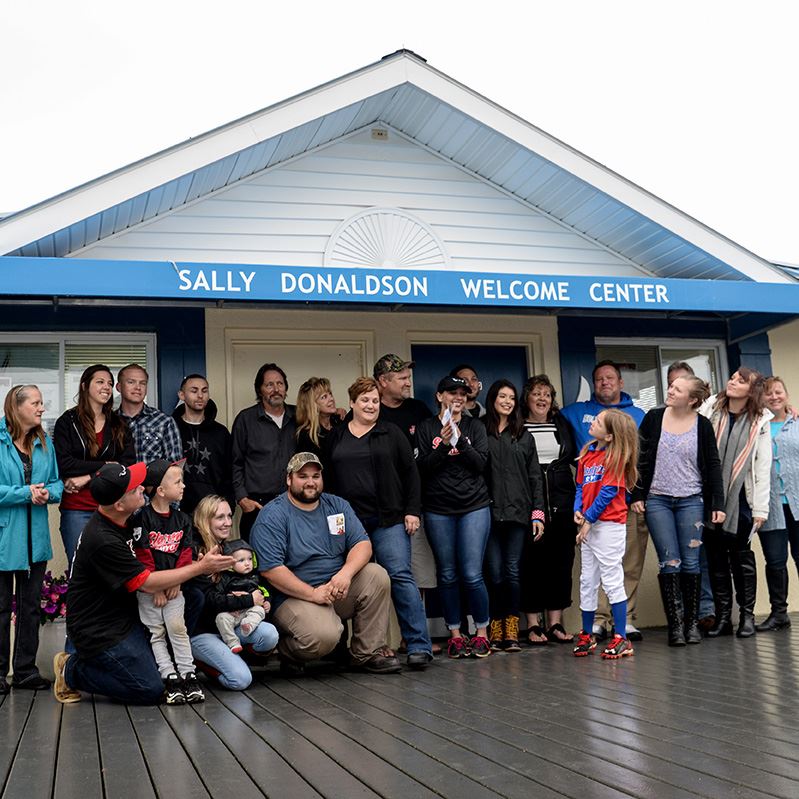 Outside of the Sally Donaldson Welcome Center with a group of people out front, photo by Angel Biel