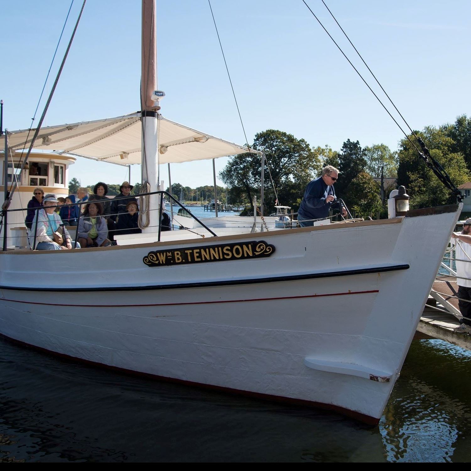 people sitting on a boat by the dock