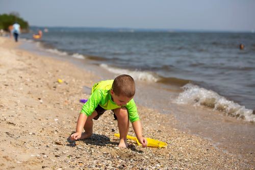 Young boy beach combing